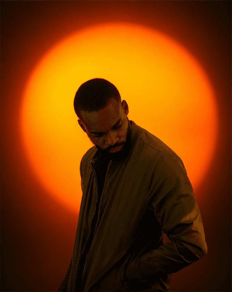 Portrait of Davidking Igwela lit against a warm glow